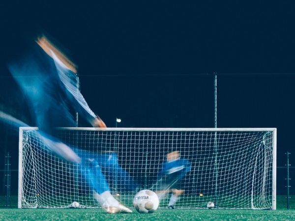 timelapse photo of soccer player kicking ball